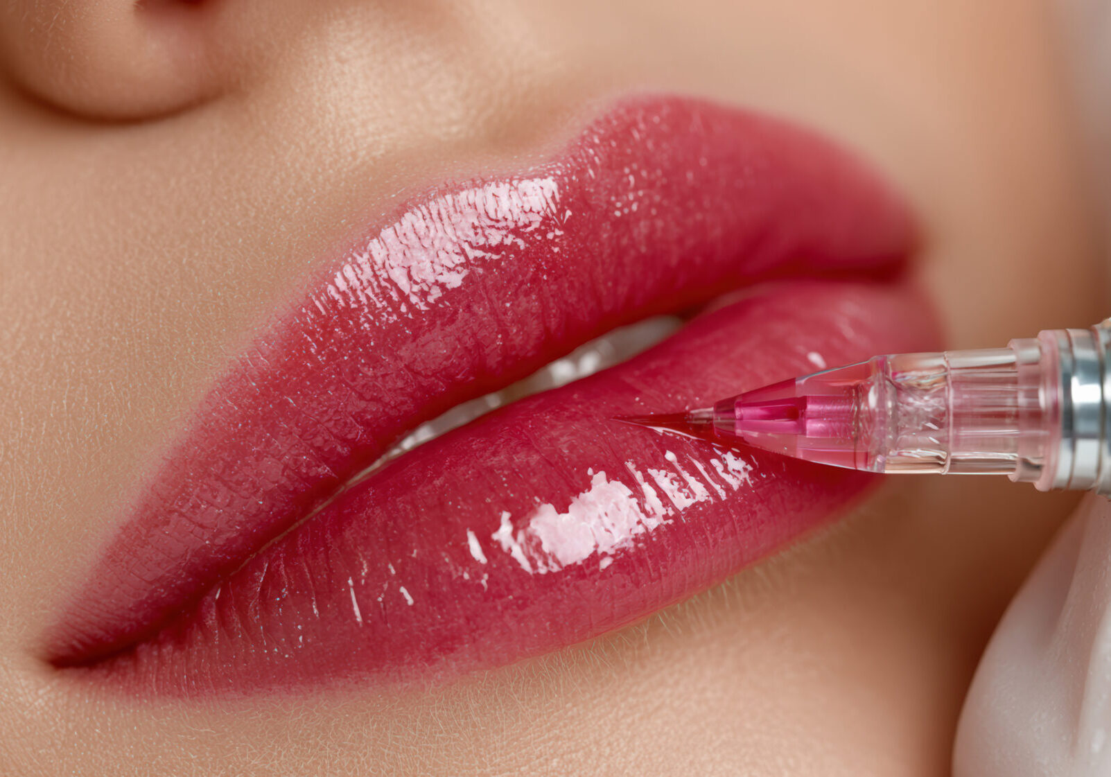 A lip cosmetic tattoo needle close up mouth permanent makeup lip pigment application with cosmetic tattoo needle glossy lip